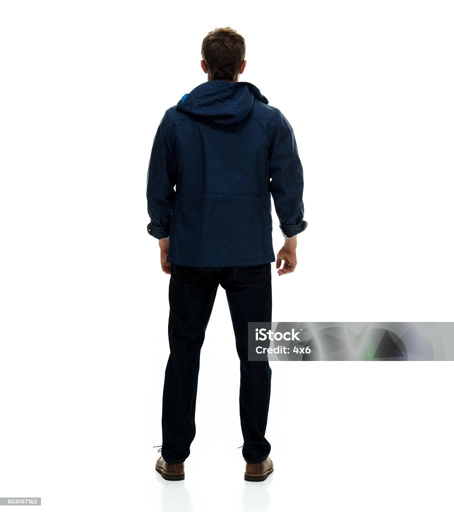Rear view of man standing and looking away Rear view of man standing and looking awayhttp://www.twodozendesign.info/i/1.png Rear View Stock Photo