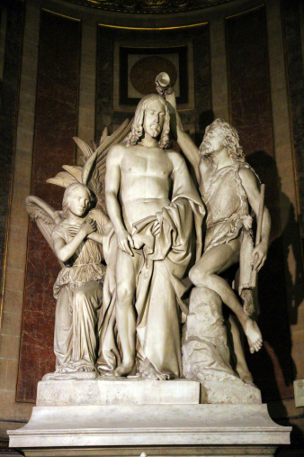 A statue of the baptism of Christ in the Church of the Madeleine in Paris.