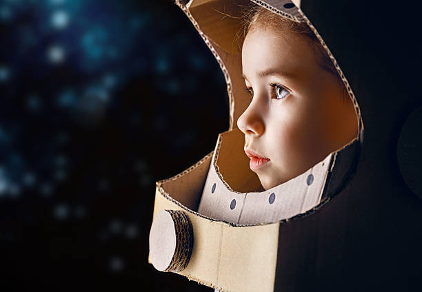 astronaut child is dressed in an astronaut costume imagination stock pictures, royalty-free photos & images
