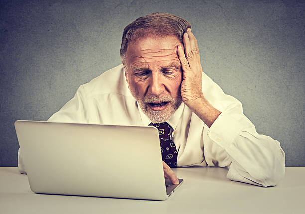 istock senior stressed man working on laptop sitting at table 503458024