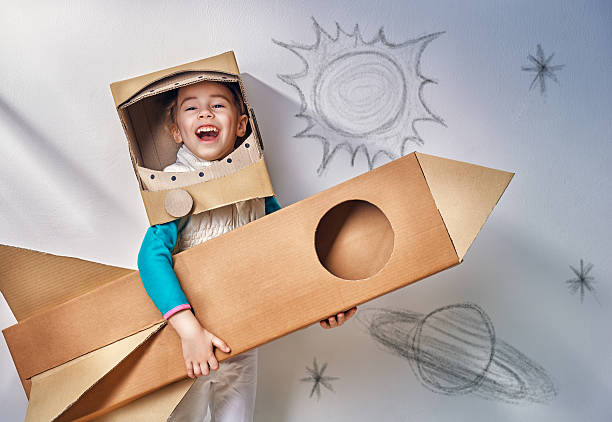 astronauta - child playing dressing up imagination foto e immagini stock