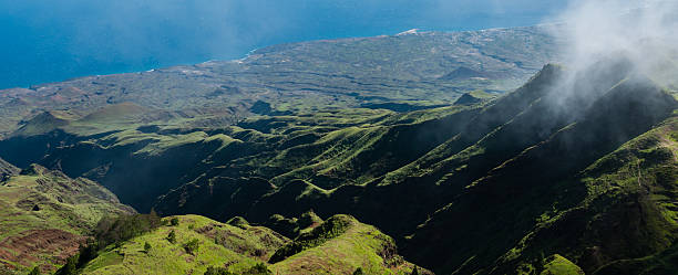 istock Steep green valley viewpoint leading to blue ocean coast of 503459490