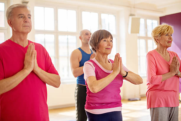 istock Active senior people doing yoga at gym 503464214