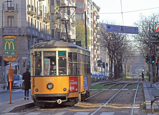 frau ist driving straßenbahn in mailand - milan italy cable car old italy stock-fotos und bilder