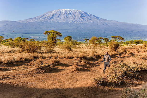 istock Photographer at Mt Kilimanjaro with Acacia Trees 503480974