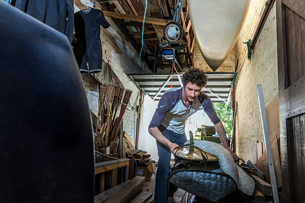 istock Repairman packing surfboard in workshop 503481974