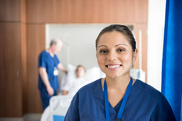 Ethnic nurse on hospital ward smiling to camera, portrait Happy female medical professional looking at camera. Head and shoulder portrait of female nurse. leanincollection stock pictures, royalty-free photos & images