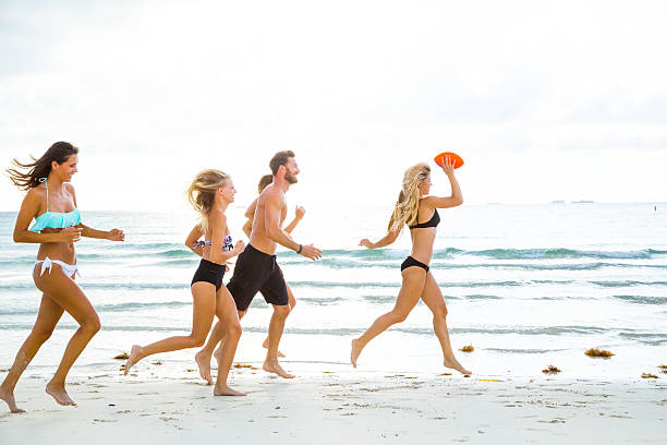 istock Friends playing ball at the beach 503488581