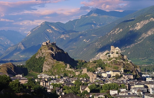 The medieval castles Valere and Tourbillon and the town of Sion Switzerland in the evening light.