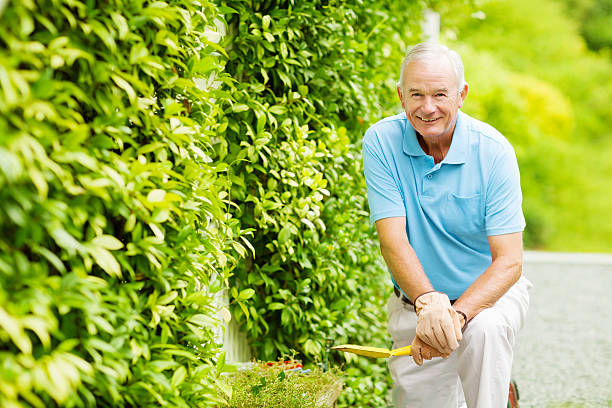 istock Happy Senior Man Holding Shovel While Gardening 503488649