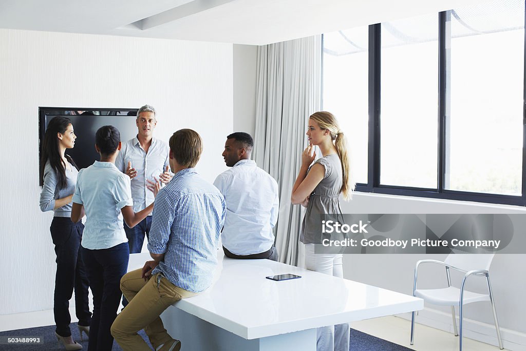 He's got the team together Shot of a creative team in a meeting Business Casual Stock Photo