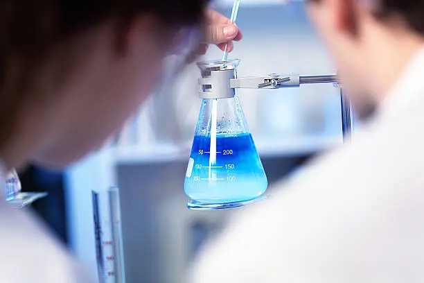 Photo of Scientists Woeking with Chemical Solution in Laboratory Horizontal