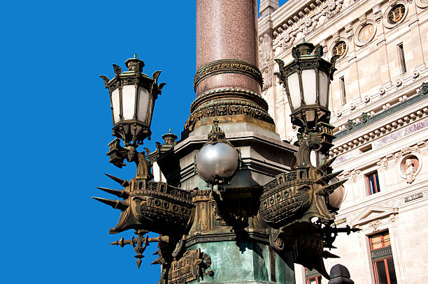 Paris, France. Sculpted bronze streetlamp in front of the famous and monumental Palais Garnier, the Paris Opera House (or simply, the Op