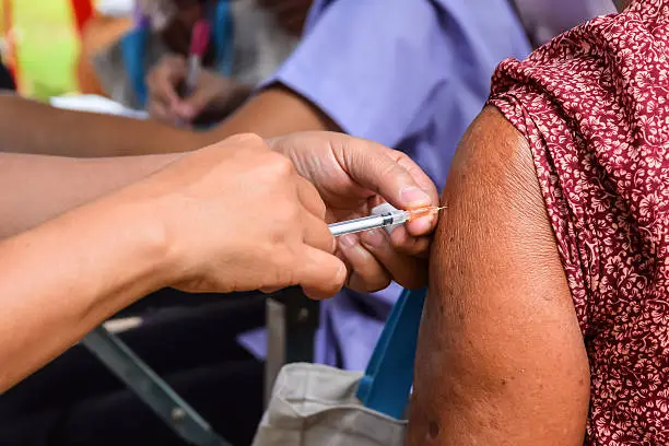 Doctor giving an injection to a patient