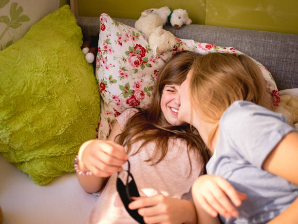 istock Adolescent girls laughing while sharing a slumber party 503490788