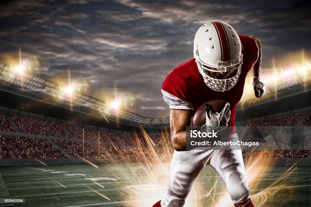 Football Player Football Player with a red uniform running on a stadium. American Football - Sport Stock Photo