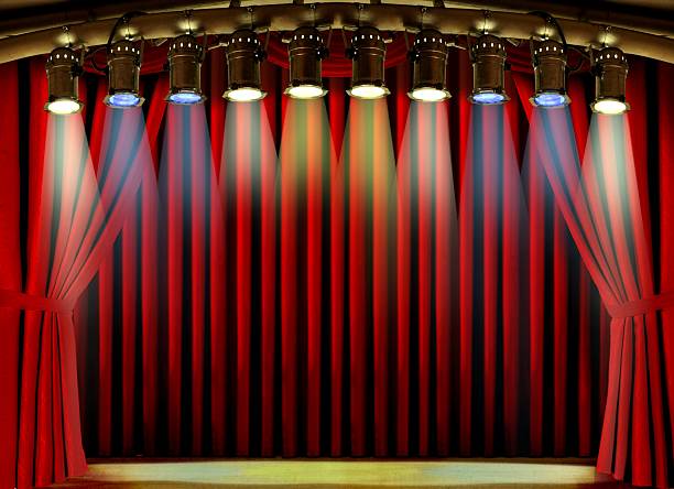 istock Empty stage with red curtain and spot lights 503492500