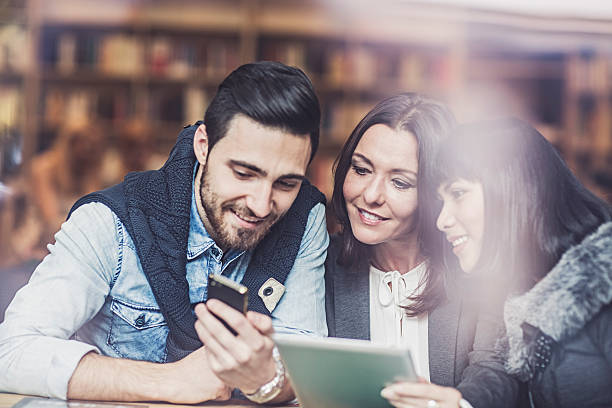 istock Three  friends watching digital tablet in  cafe 503492820