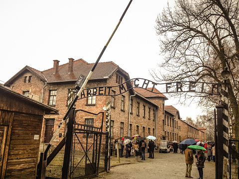 Oswiecim, Poland - March 17, 2014: The entrance of the notorious Auschwitz I, a former Nazi extermination camp and now a museum. In English, the words mean 'Work sets you free'.