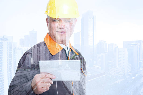istock portrait engineer in yellow hardhat with tablet 503507482