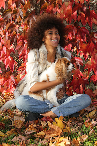 istock young black lady smiling and playing with her dog 503509018
