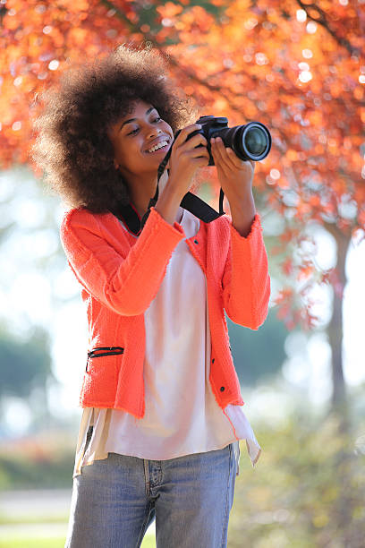 istock Young black lady trying her new camera for first time 503509212