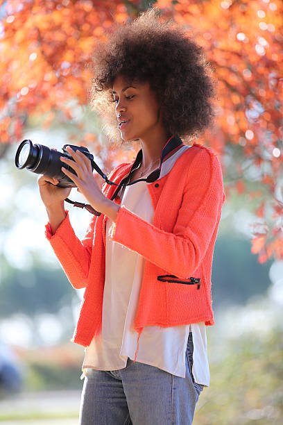 istock Young black lady trying her new camera for first time 503509232