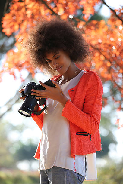 istock Young black lady trying her new camera for first time 503509294