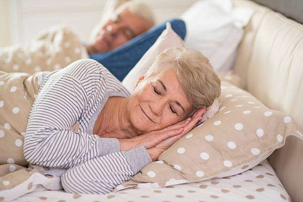 Woman and her husband sleeping comfortably stock photo