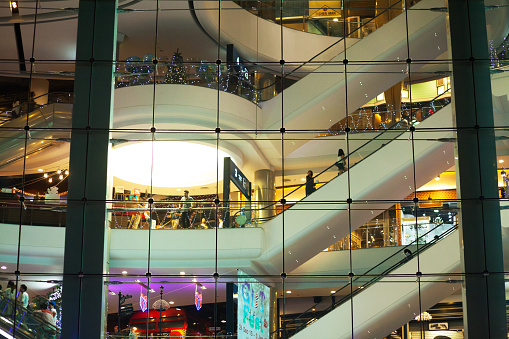 Bangkok, Thailand - December 31, 2015: New year shopping scene in Terminal21 Mall in Bangkok, seated at junction Sukhumvit - Asok. View up facade and shot of people on floors and escalators. New years night.