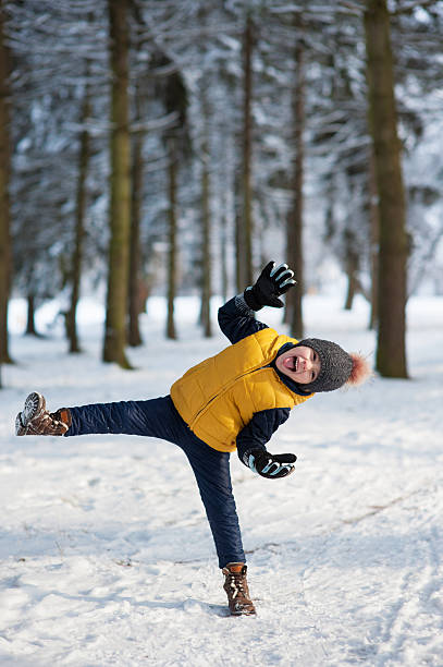 istock boy raised his leg and hands  showing tongue 503514398