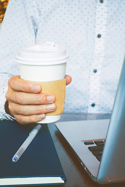 istock businessman hand holding coffee 503516756