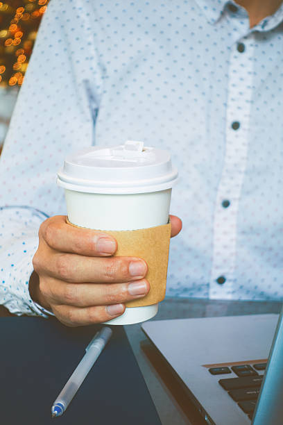 istock businessman hand holding coffee 503517014