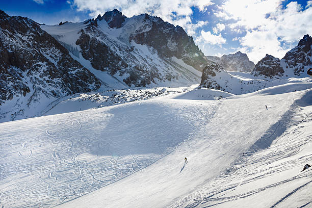 istock Skiers going down the slope under ski lift. 503517268