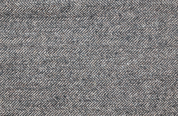 Close up of a brown tweed fabric Close up of a brown tweed (herringbone) woolen fabric tweed stock pictures, royalty-free photos & images