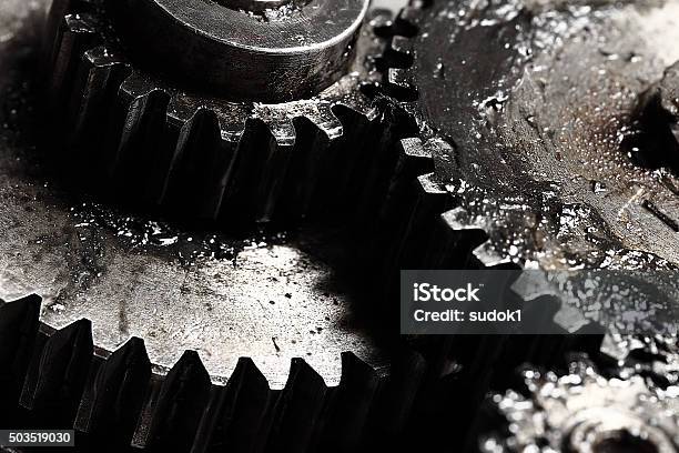 Oiled Gears As Small Parts Of Large Mechanism Stock Photo - Download Image Now - Lubrication, Industry, Gear - Mechanism