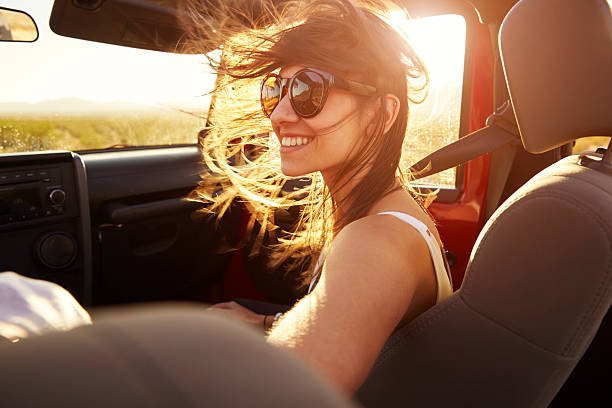 Woman Passenger On Road Trip In Convertible Car Woman Passenger On Road Trip In Convertible Car convertible photos stock pictures, royalty-free photos & images