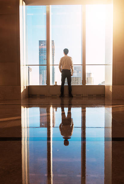 istock Businessman looking city through the window 503519846