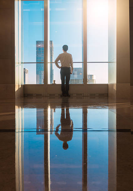 istock Businessman looking city through the window 503520032