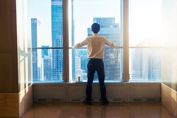 istock Businessman looking city through the window 503520570