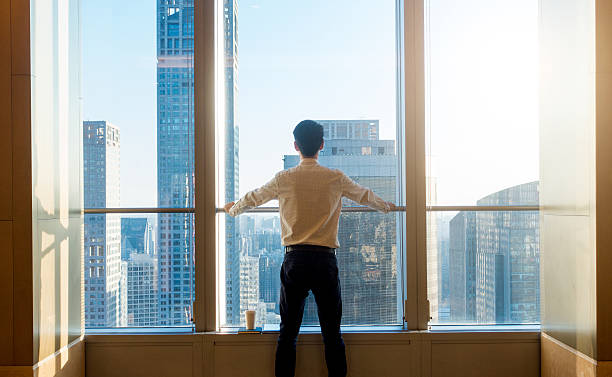 istock Businessman looking city through the window 503520666