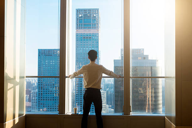istock Businessman looking city through the window 503520728