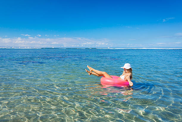 istock Woman floating on raft in tropical ocean 503523303