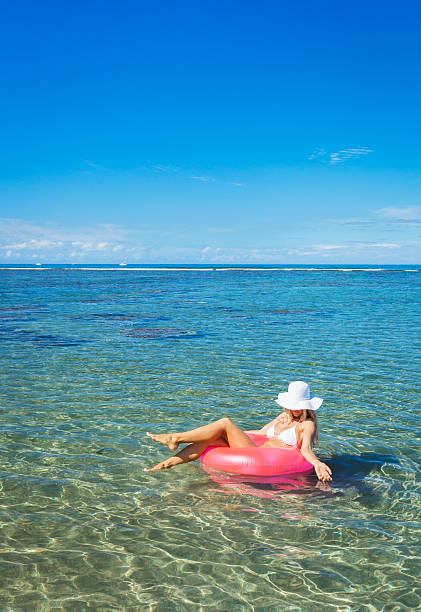 istock Woman floating on raft in tropical ocean 503523305