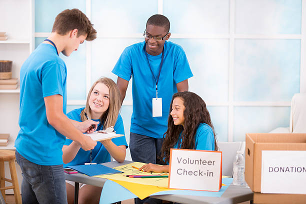 istock Teen boy registers at volunteer check-in table. Multi-ethnic group. 503524243