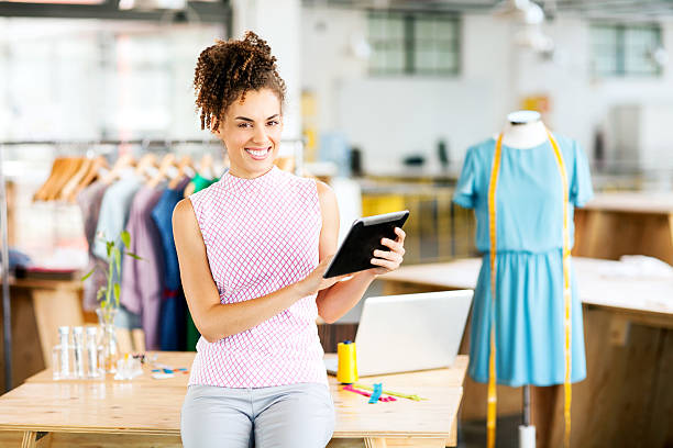 istock Smiling Female Fashion Designer Using Digital Tablet In Workshop 503524561