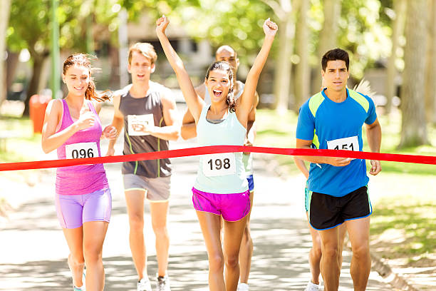 istock Female Marathon Runner Crossing Finishing Line 503524743