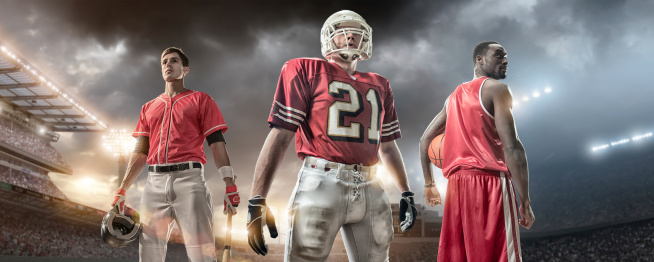 Composite image of Professional Baseball Player, American Football Player and Basketball Player standing together outside under stormy evening sky in floodlit stadium full of spectators.