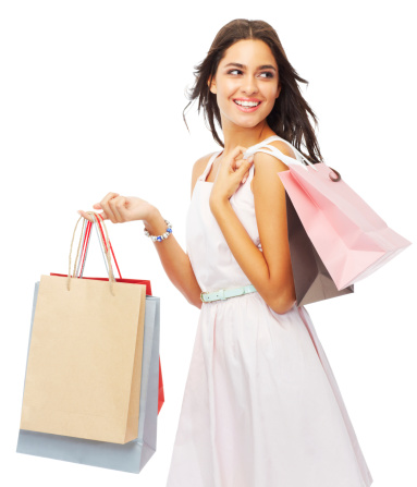 Shot of an attractive young woman holding shopping bags isolated on white