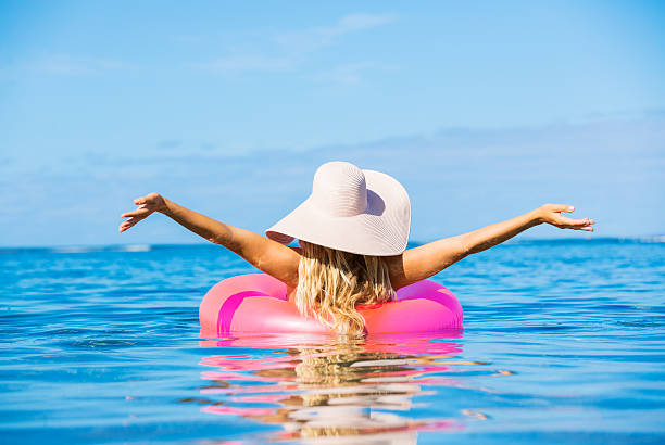istock Woman floating on raft in tropical ocean 503528085